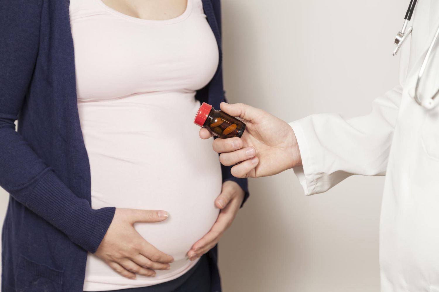 doctor giving pregnant woman drugs