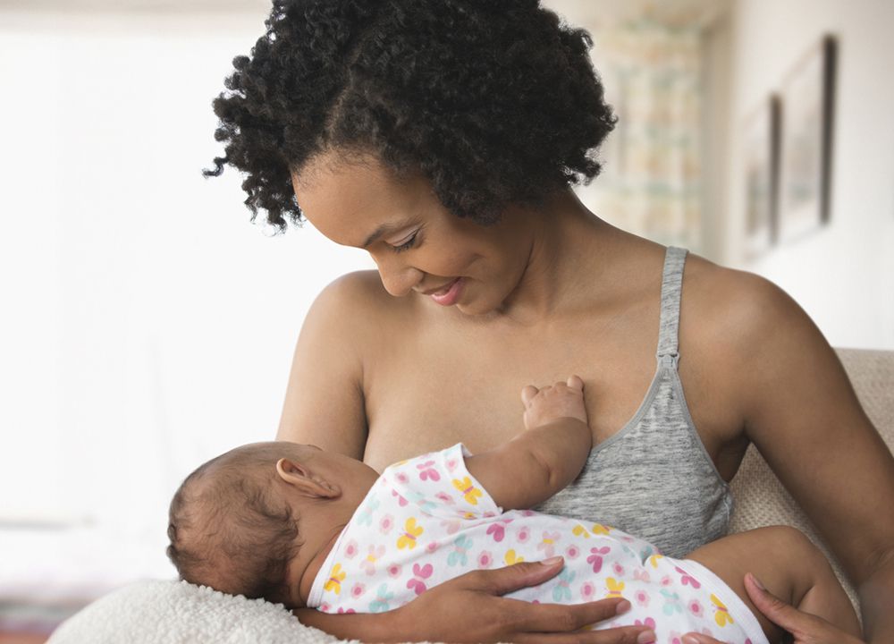 mom breastfeeding baby at home