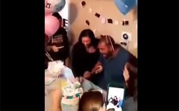 mom and dad cutting gender reveal cake