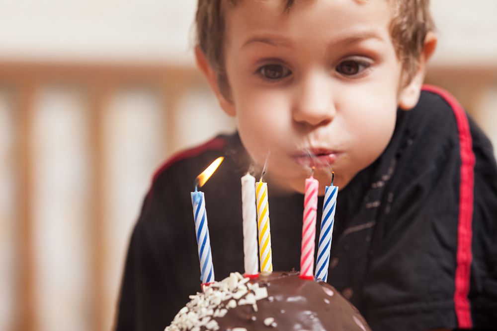 boy-blowing-out-birthday-candles.jpg
