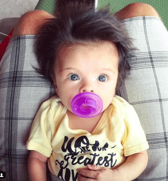 Baby girl with lots of hair.