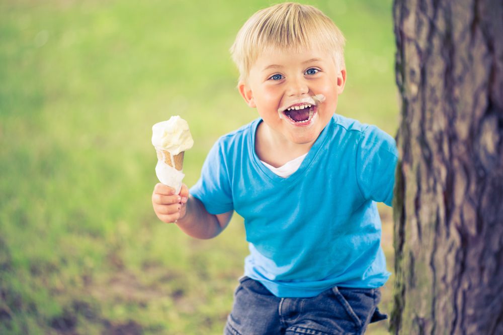 Happy Boy With an Ice Cream Cone Outside
