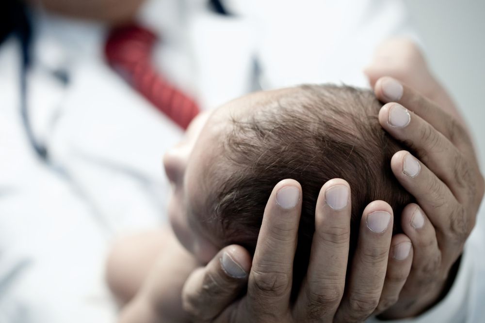 doctor holding small baby