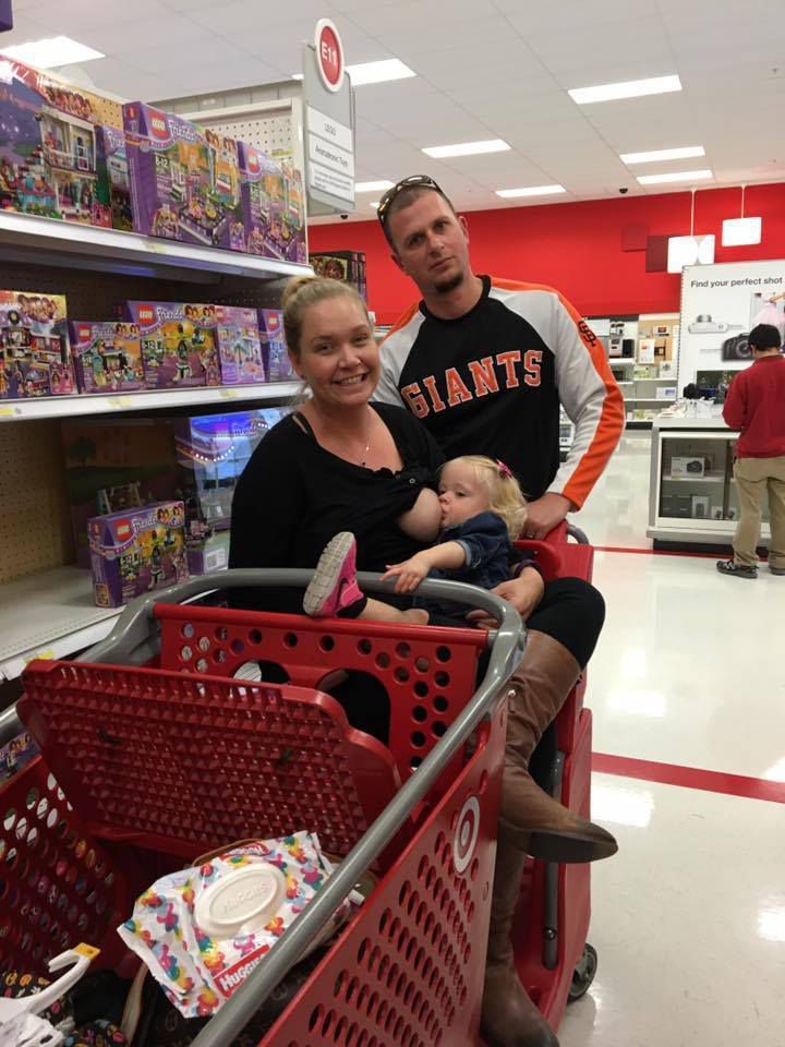 dad pushing breastfeeding mom in target cart
