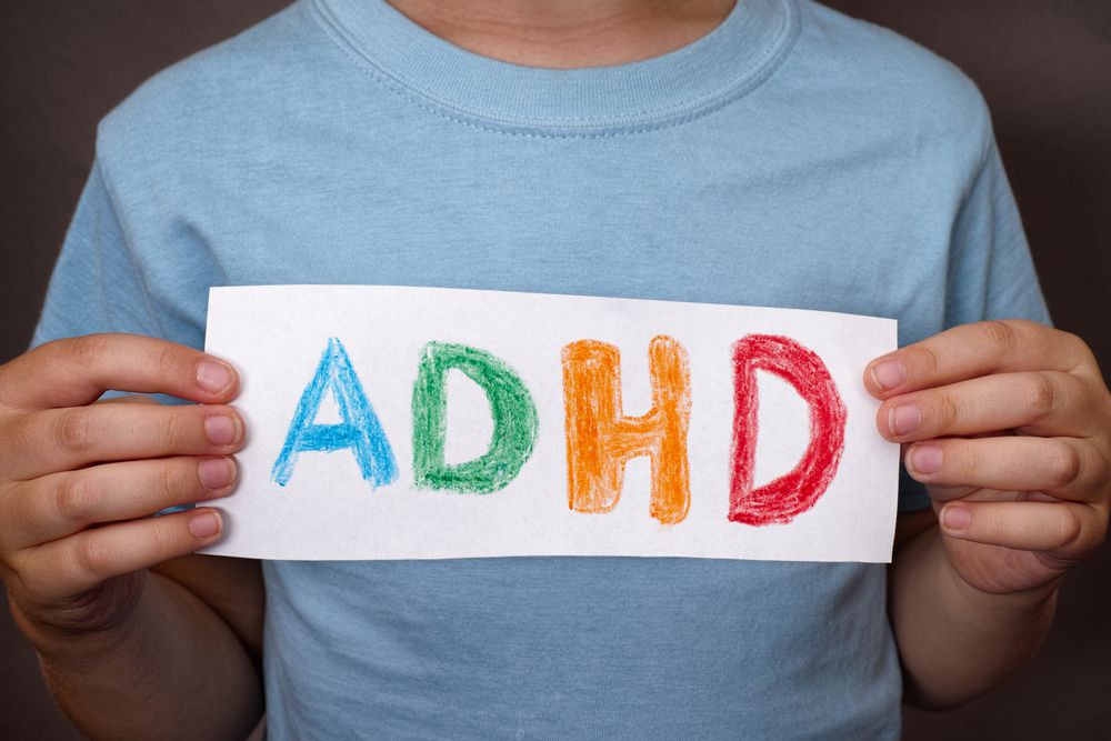 child holding ADHD sign