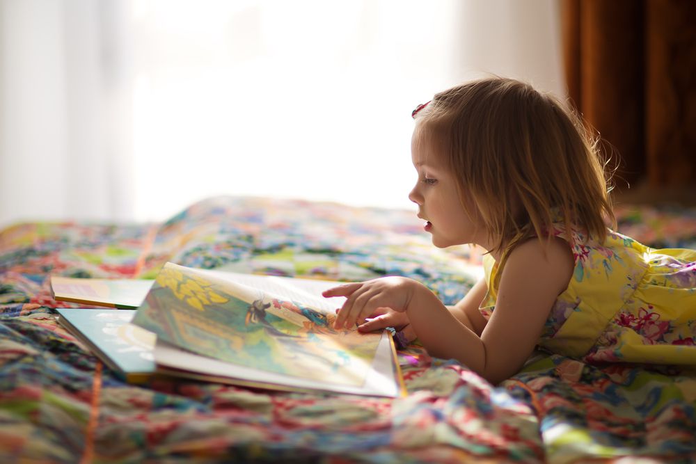 girl reading colorful book