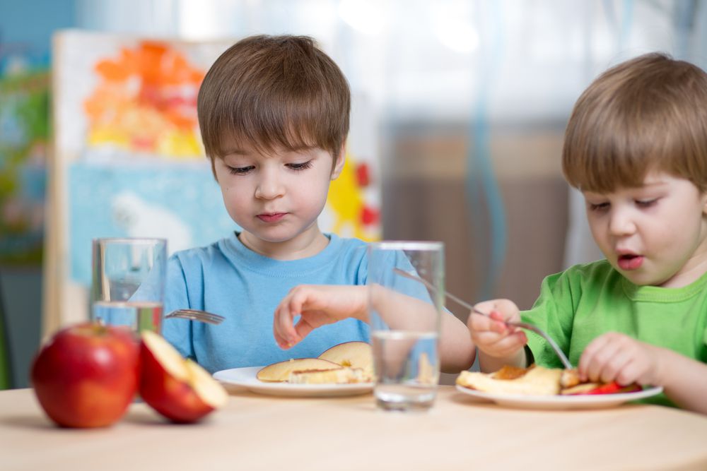 Two Boys Eating at Day Care