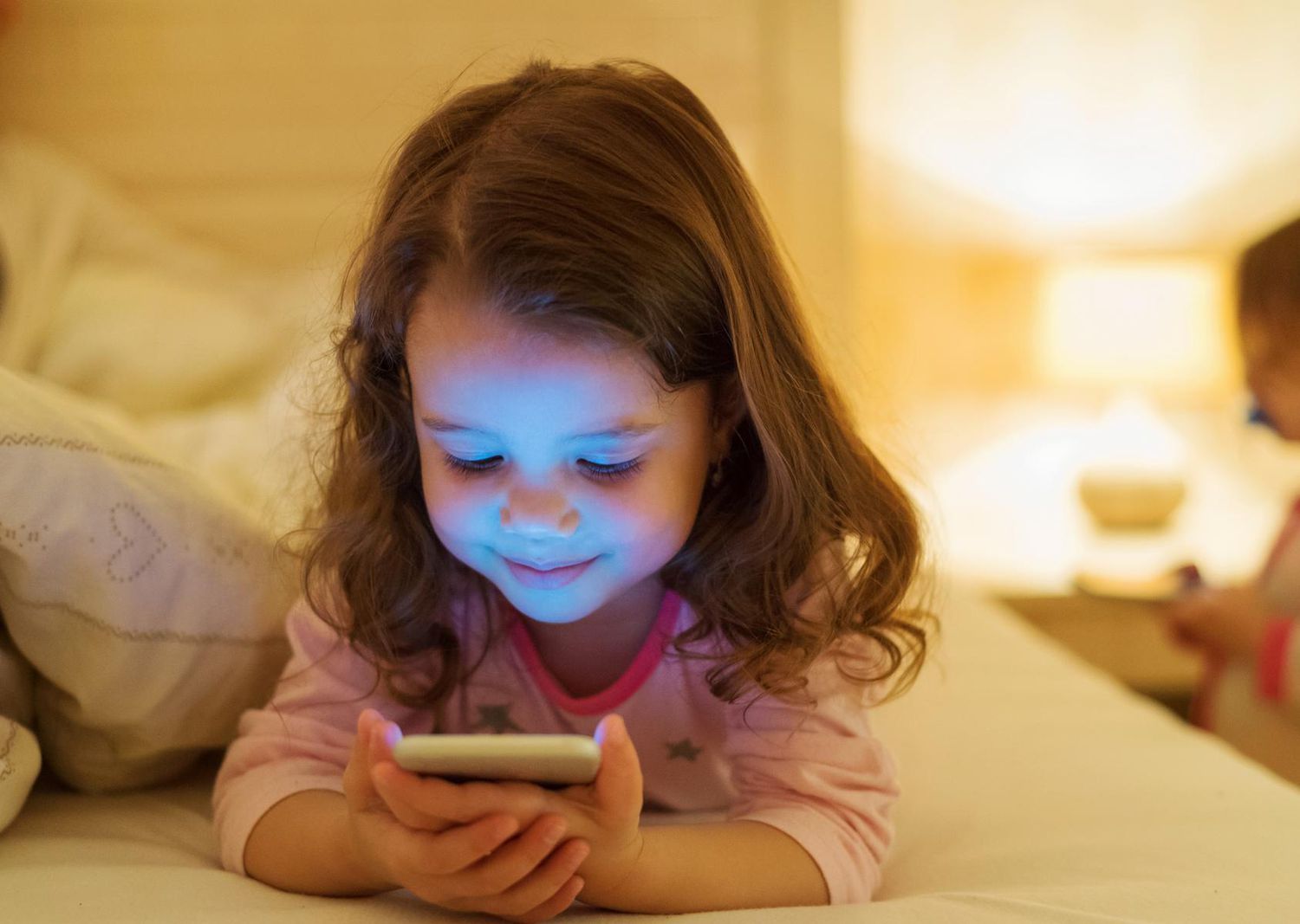 Kid With Phone in Bed