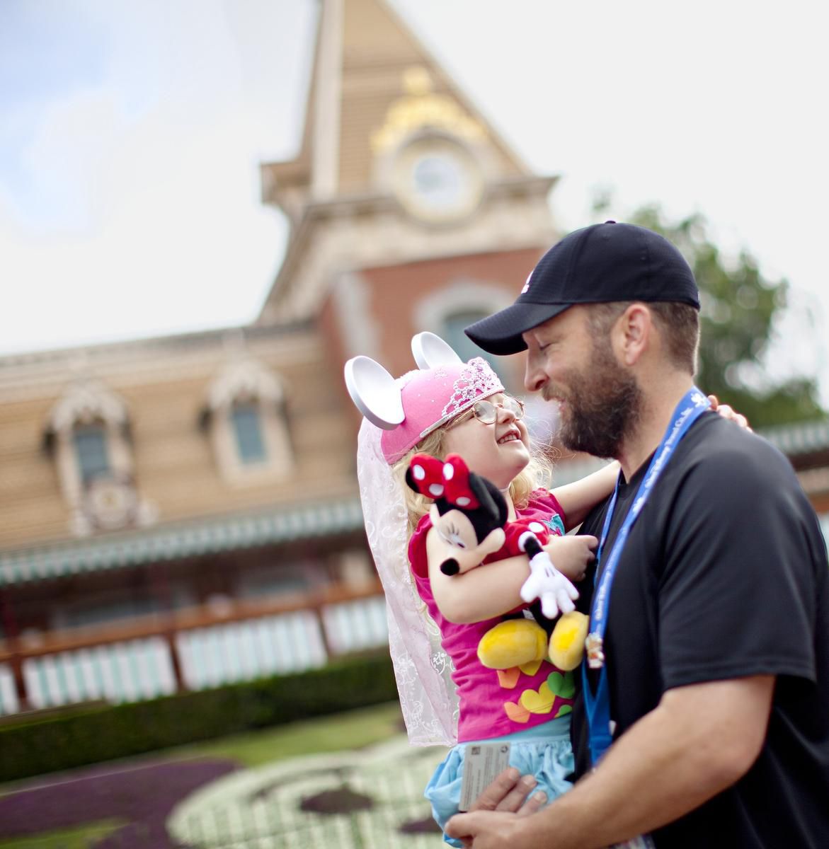 Disney Theme Park Price Father Holding Daughter with Souvenirs