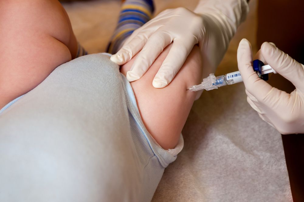baby getting vaccine shot in thigh