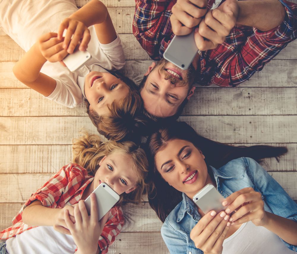 family using smartphones