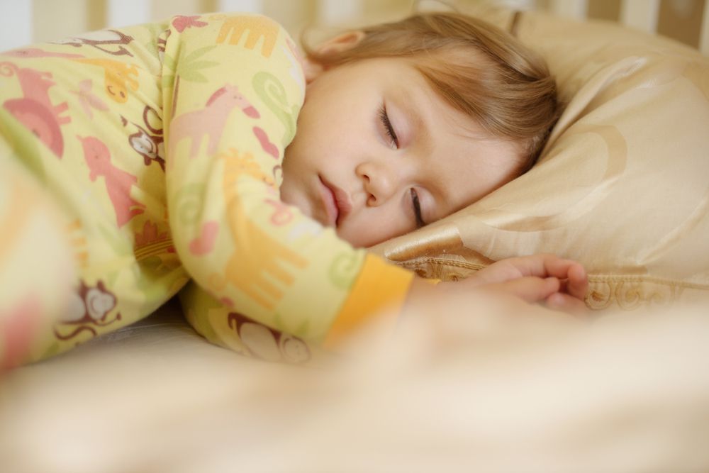 preschool girl falling asleep in bed