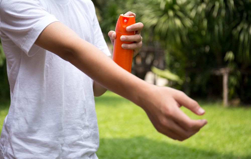 Zika Protection Young Boy Sprays Orange Bottle Bug Repellant