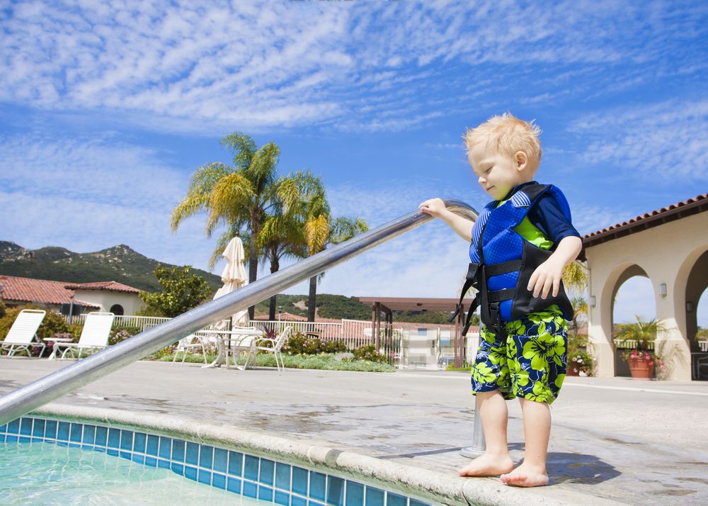 Pool Pledge Toddler in Life Jacket Steps In Pool
