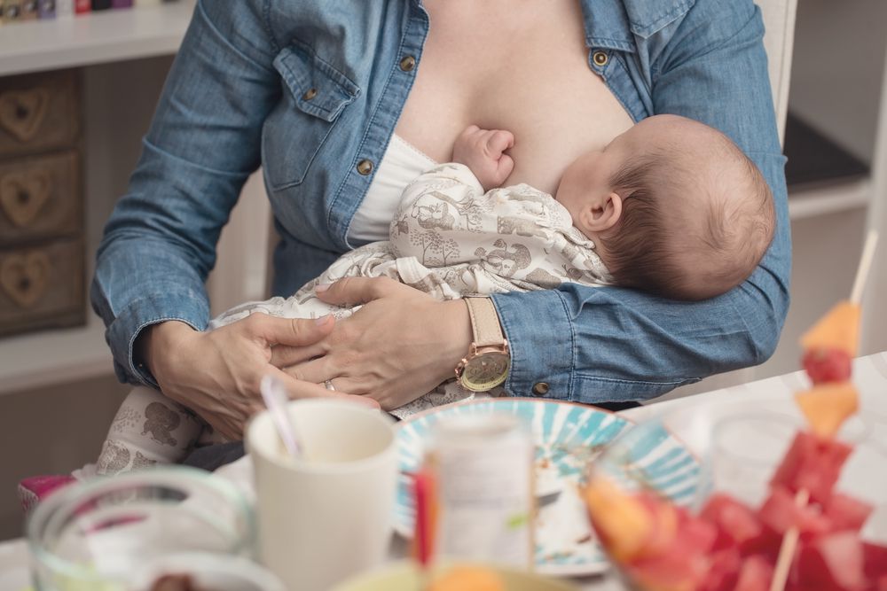 Mother Breastfeeding During Lunch