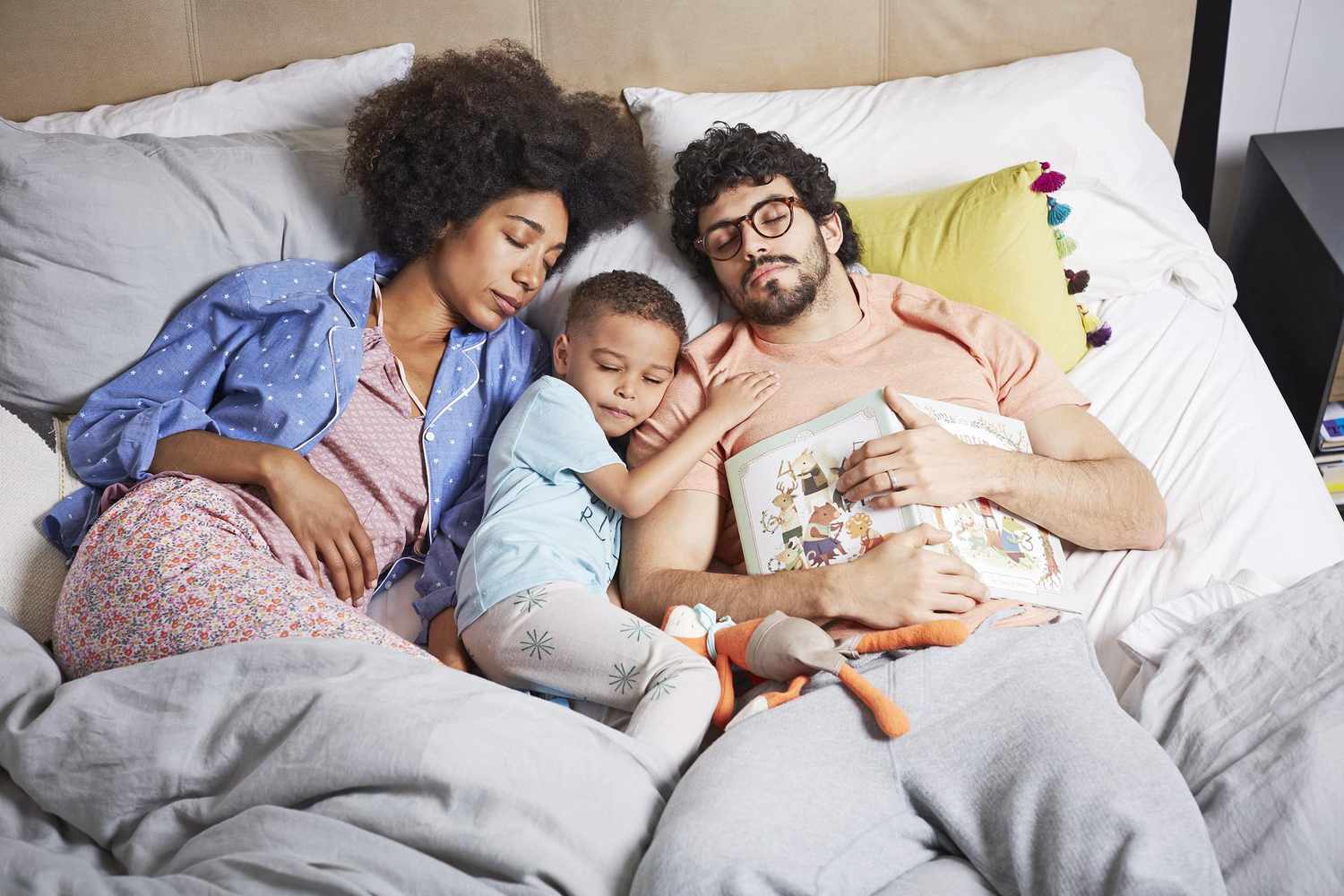 Family Fell Asleep On Bed With Book