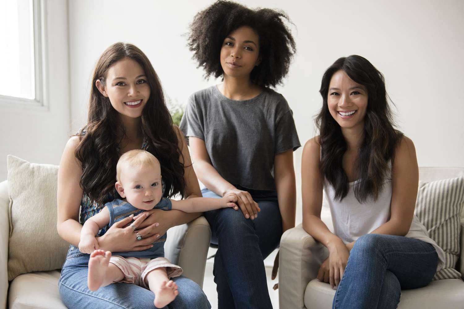 Group of smiling friends with a baby