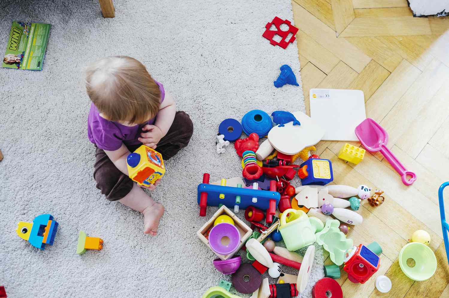 baby girl with toys scattered
