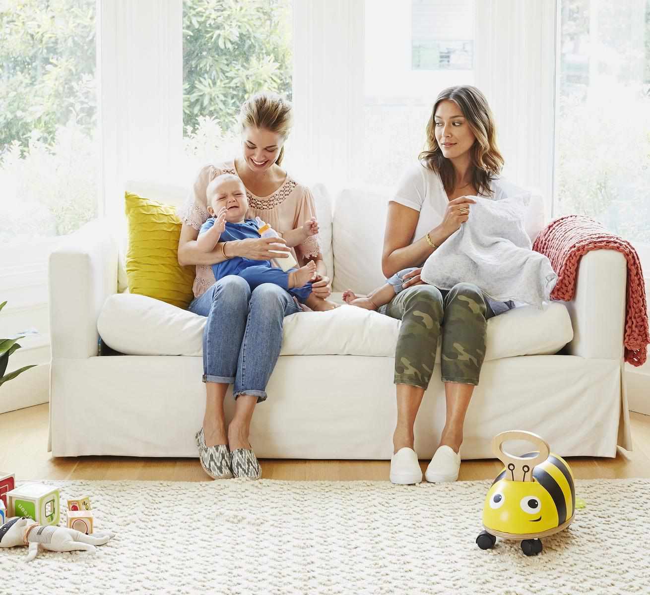 Two Moms Sitting on Couch with babies