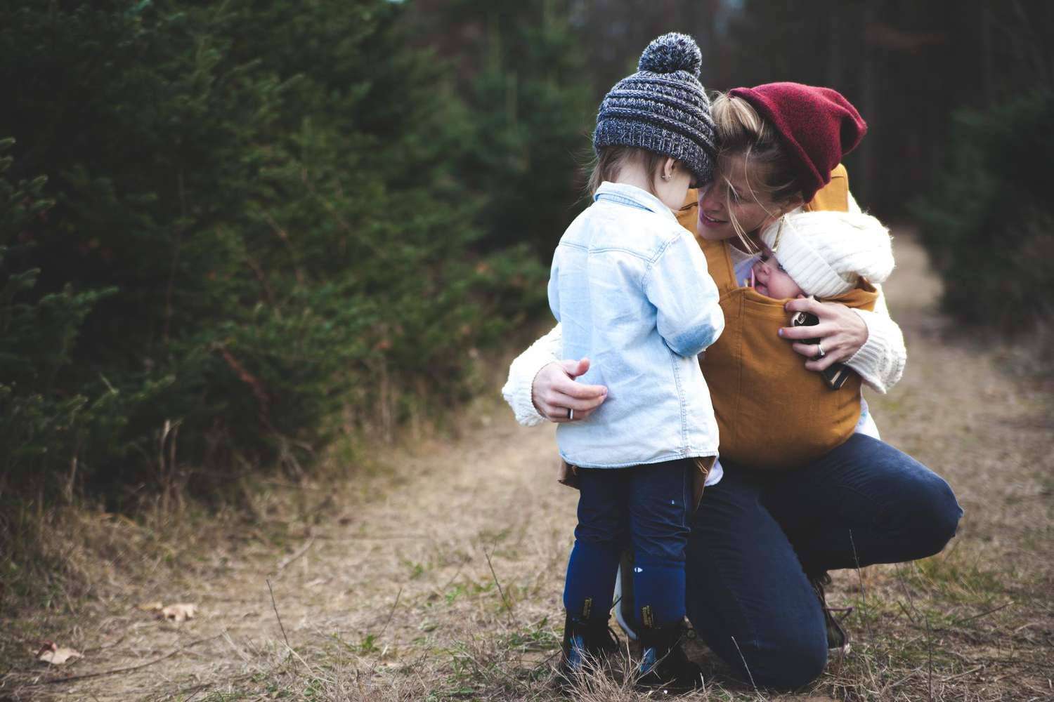 Mother Holding Baby and Talking to Other Child Outside Hike