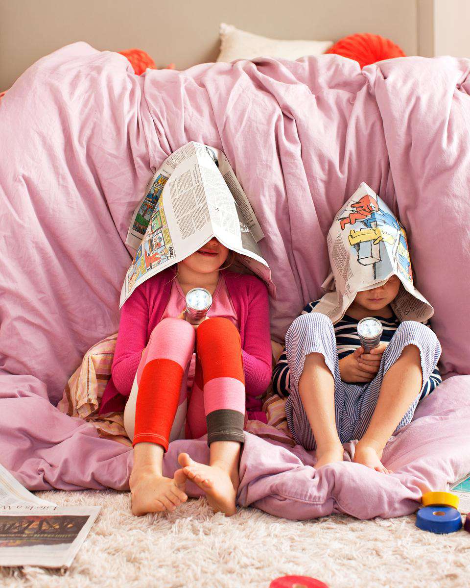Two Girls Play Silly Game Newspaper on Head