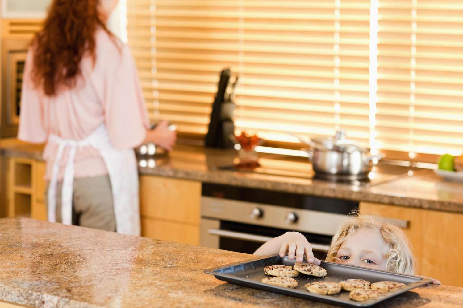 Child Sneaking Cookies From Kitchen Counter