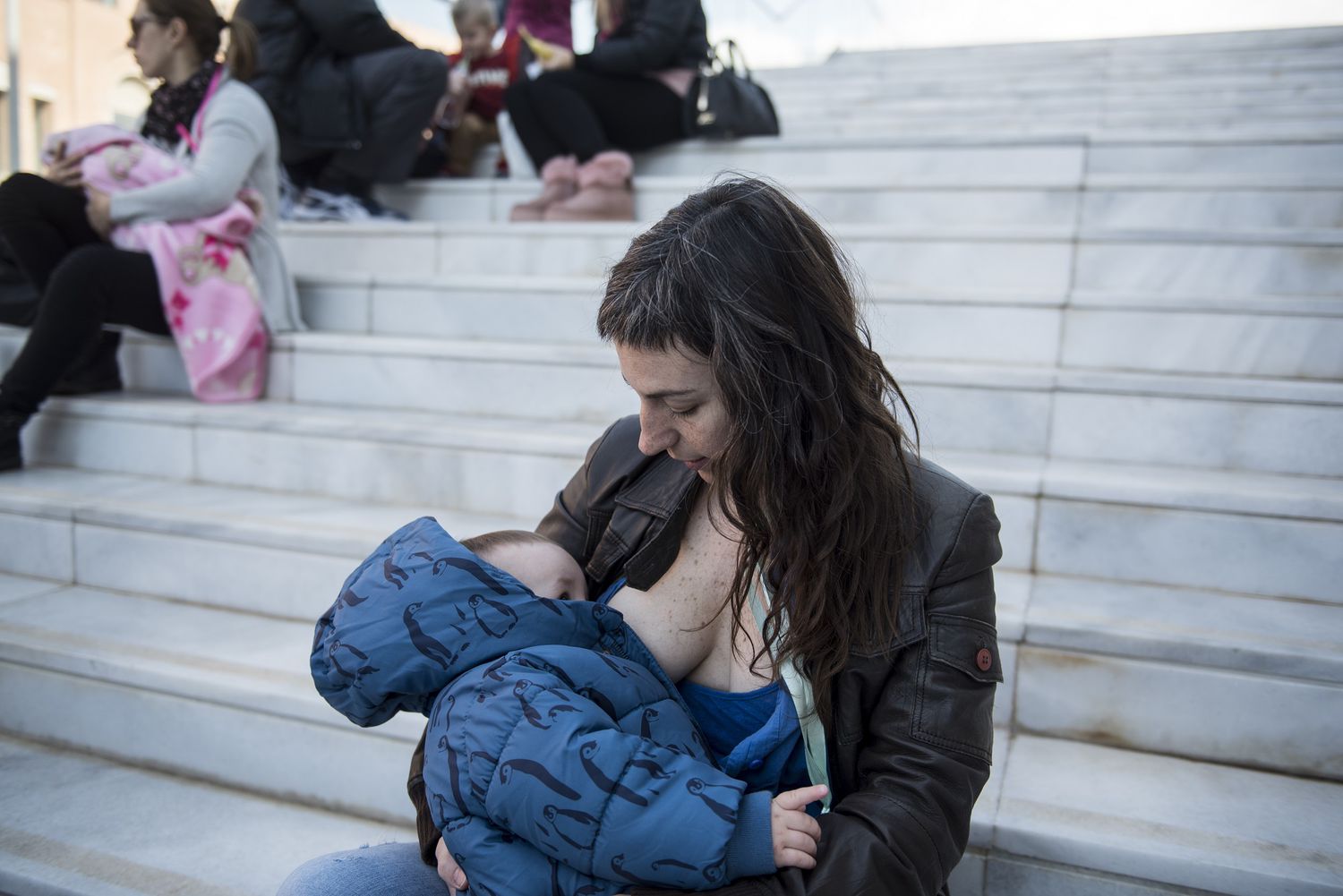 Mother Breastfeeding Baby in Public on Stairs