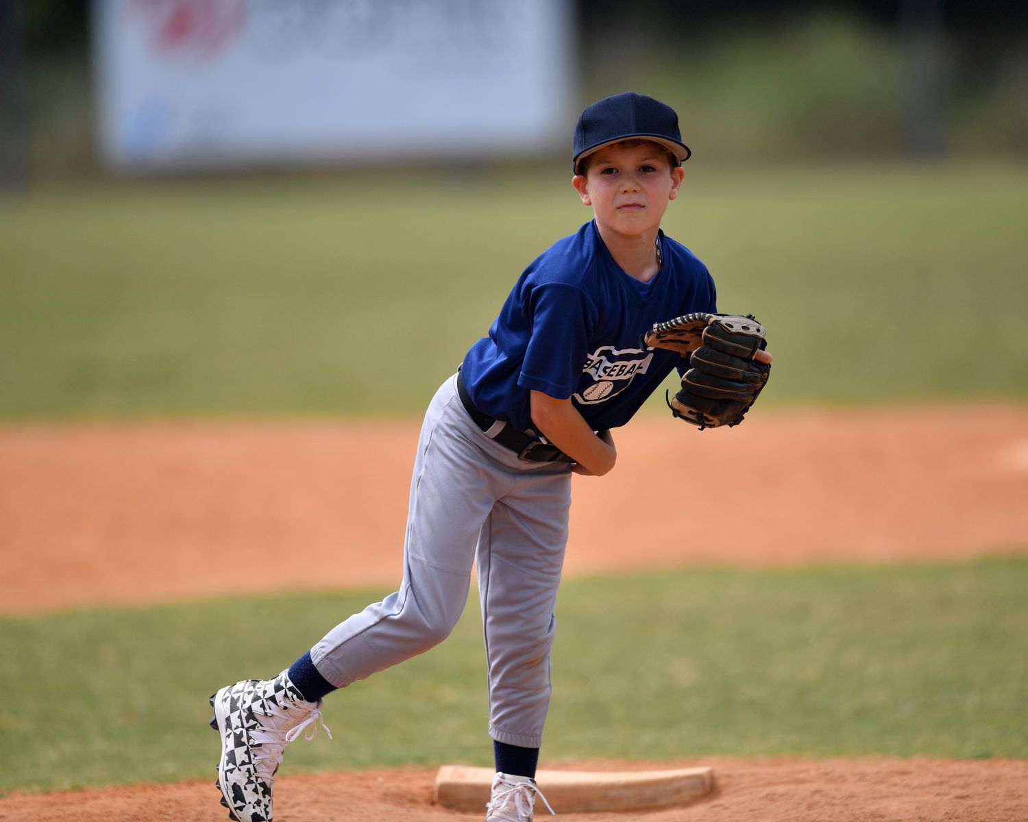 Young Boy Playing Baseball on Field