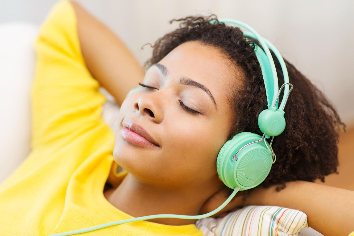 African-American woman listening to music with her eyes closed