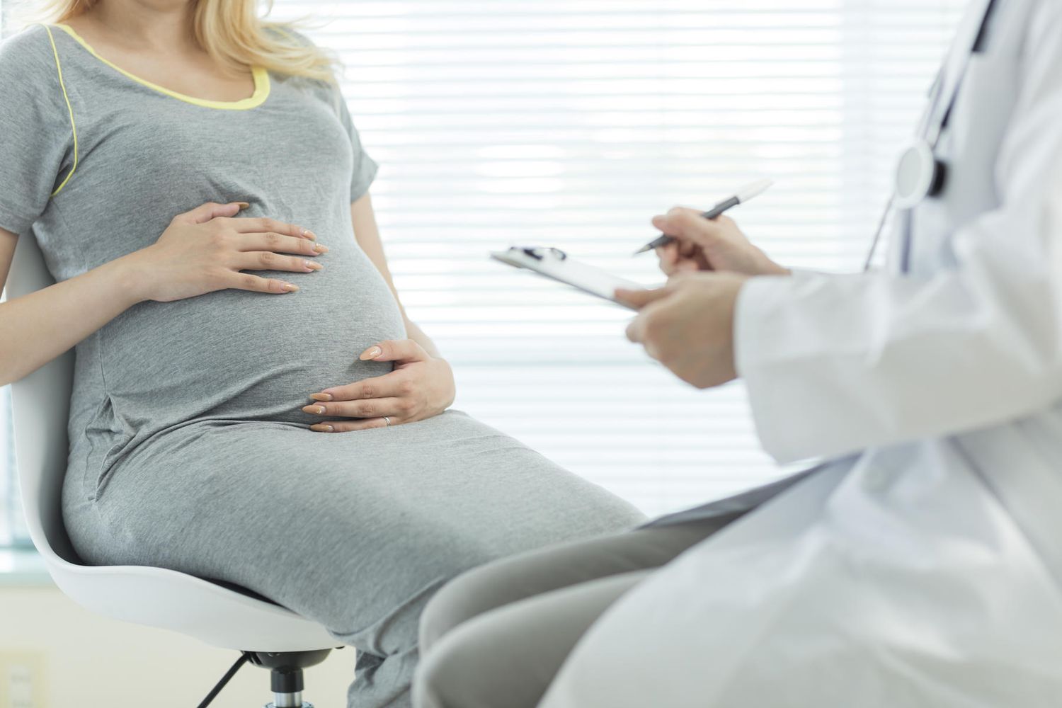 blond pregnant woman at doctors office
