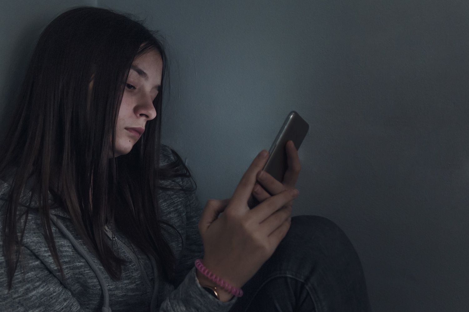 Young Teen Girl Upset On Cell Phone Dim Light