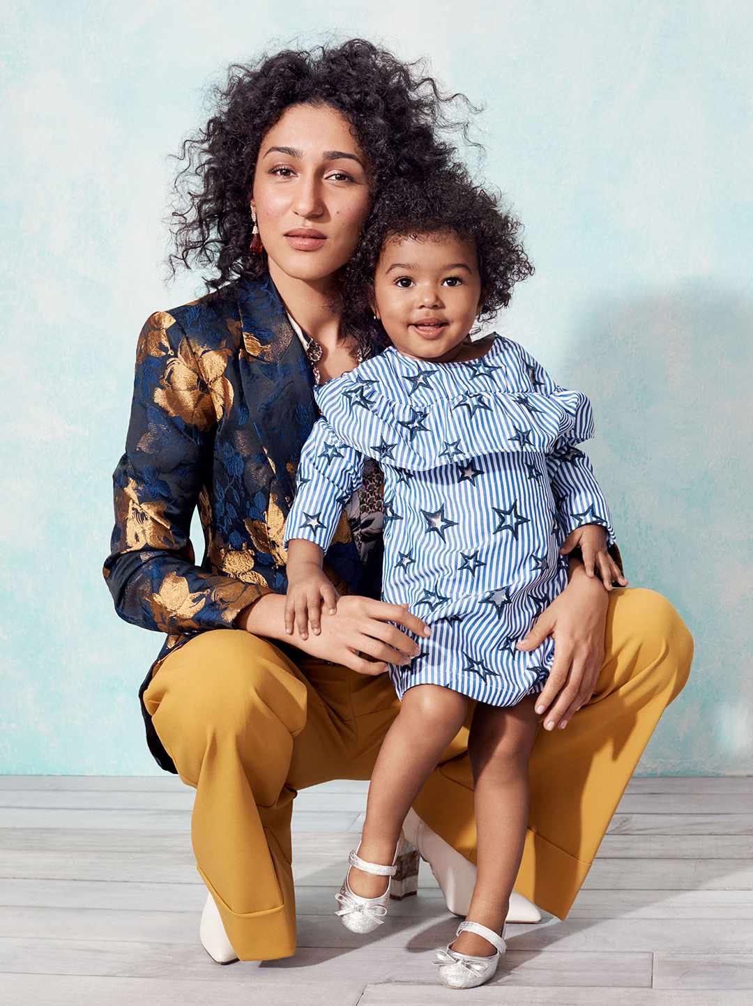 mom wearing navy and gold blouse with child