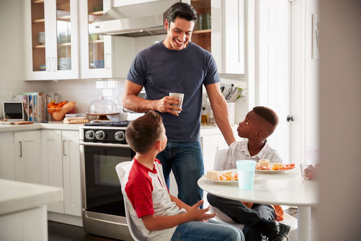 Dad with son and friend in kitchen playdate