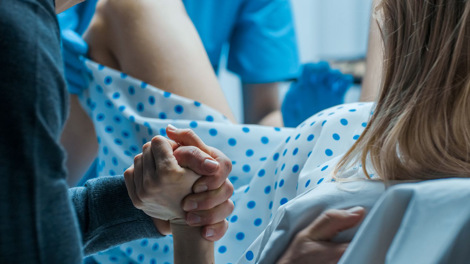 Woman In Labor Pushing Holding Mans Hand