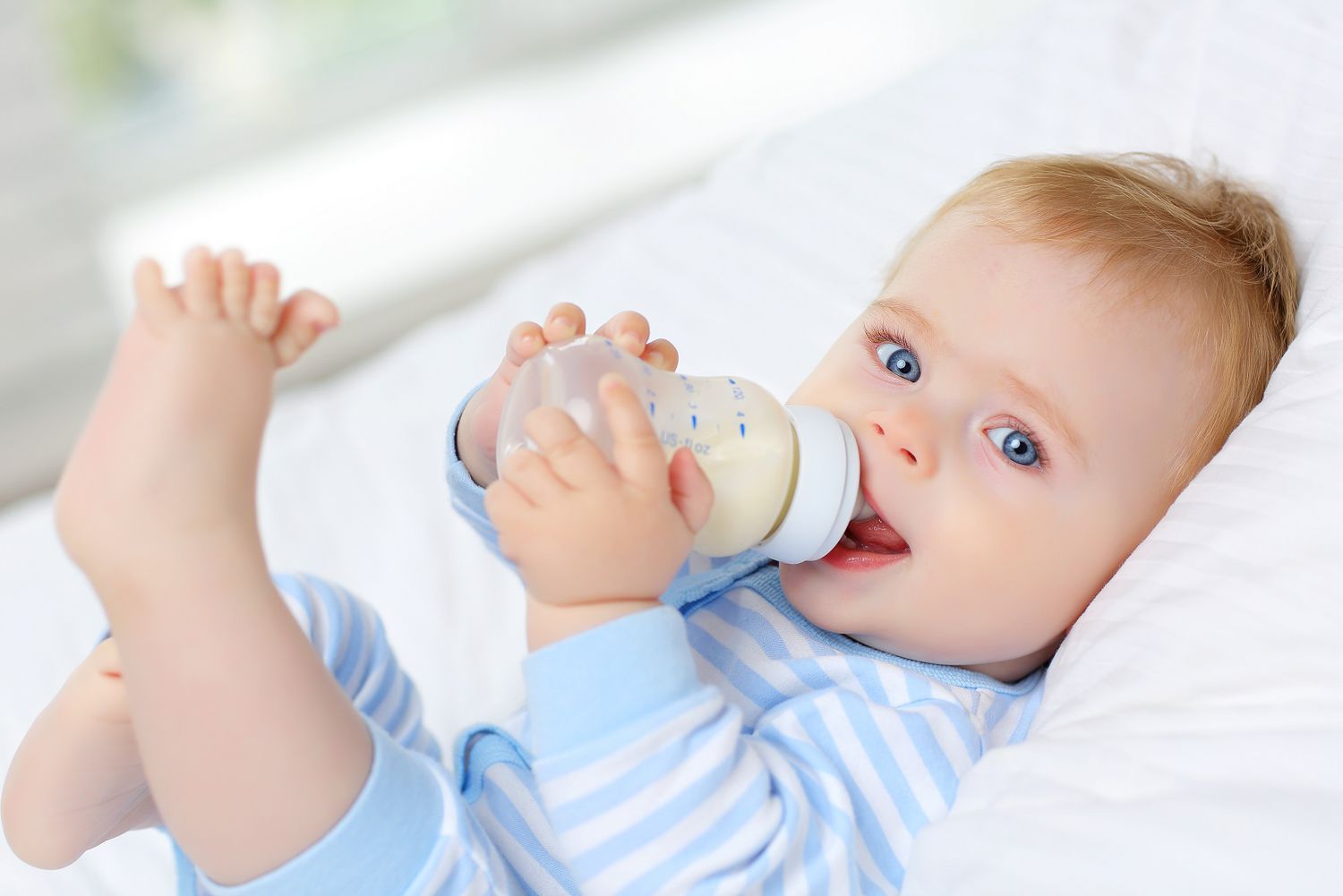 Baby Drinking Bottle Milk Foot in Air