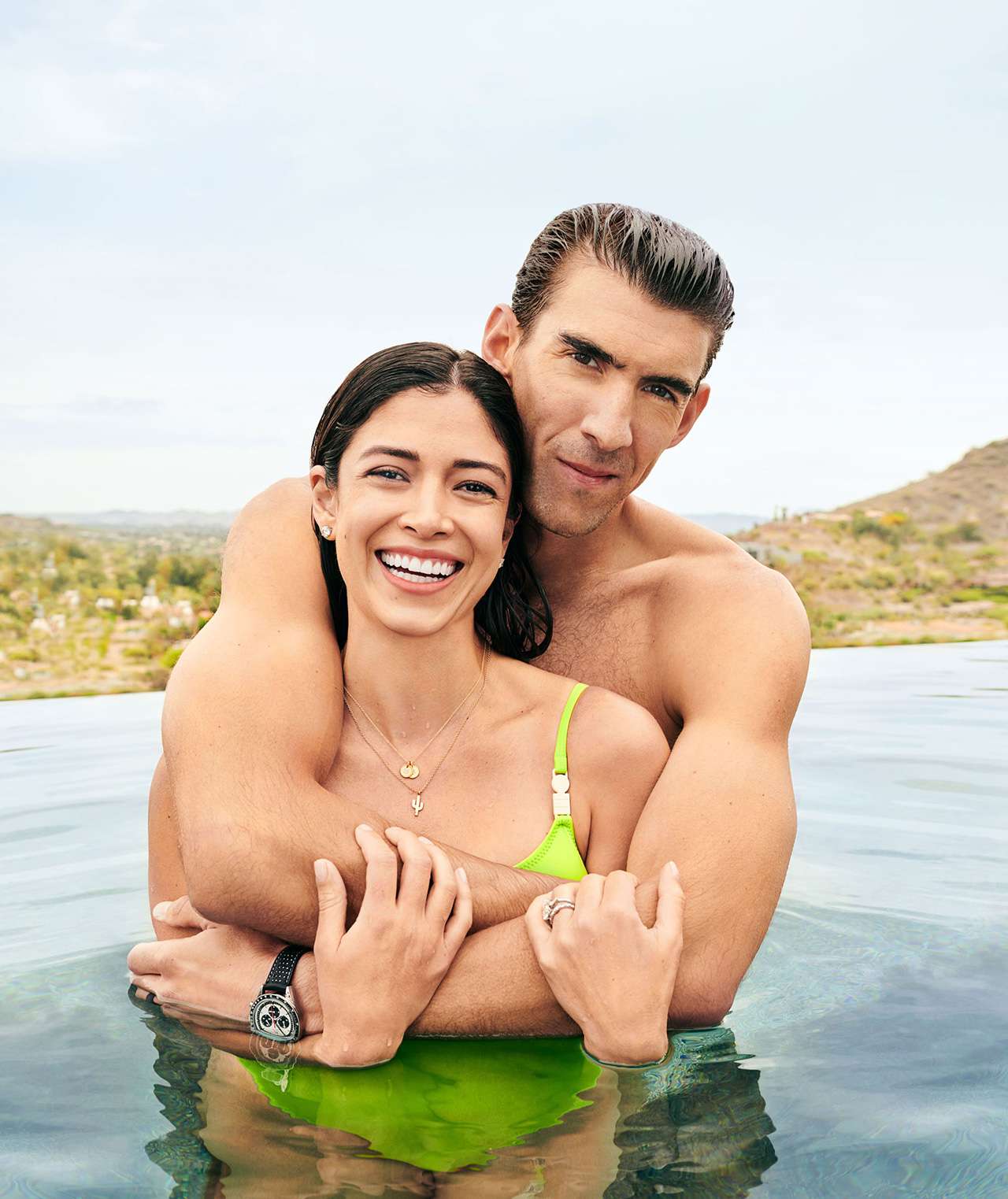 Michael and Nicole Phelps posing in pool