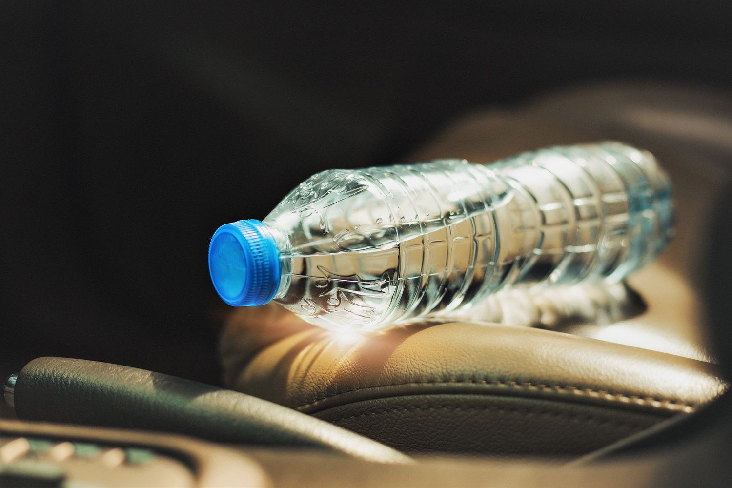 Close-Up Of Water Bottle On Car Seat