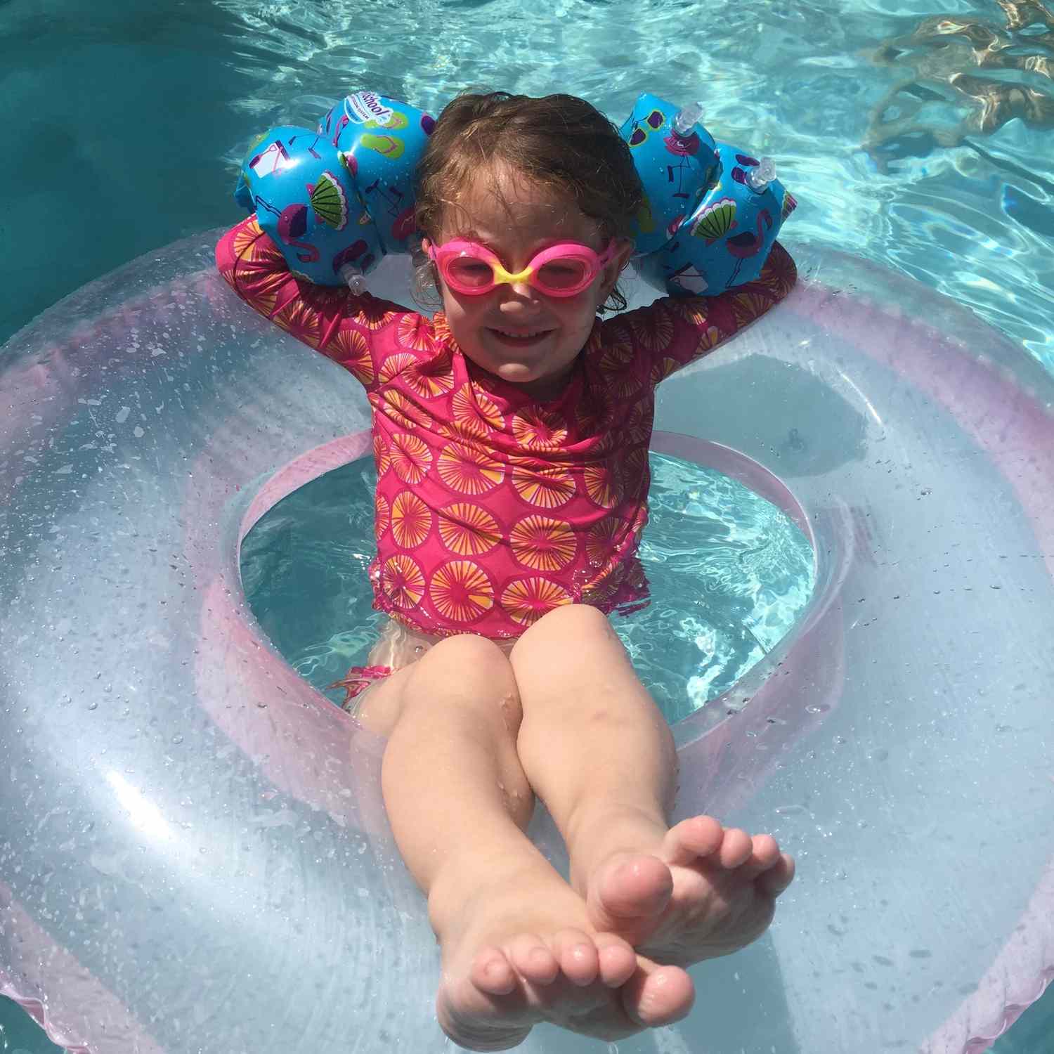 Child floating in swimming pool