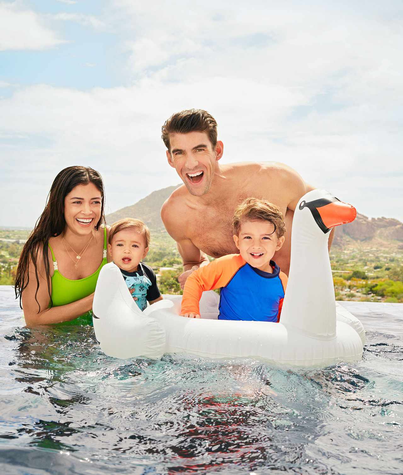 Phelps family having fun in pool with swan pool tube