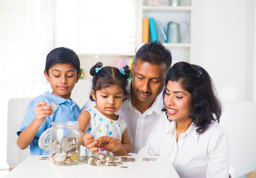 Parents Teaching Kids How to Save Money with Coins in Jar