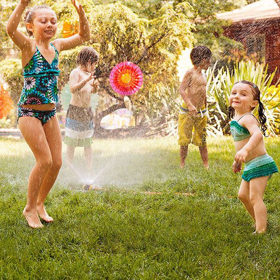 Kids dancing in sprinklers
