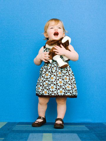pudgy toddler holding stuffed animal