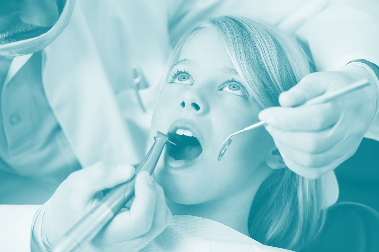 child with open mouth at dentist