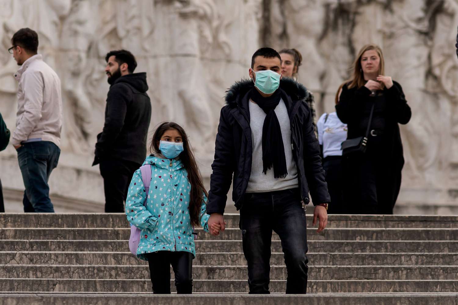 People wear face protective masks in the Altar of the fatherland (Altare della Patria) on March 5, 2020 in Rome, Italy. Today family Minister Elena Bonetti said that the government is studying ways to help families after it decided to close Italy's schools and universities until the middle of March because of the coronavirus emergency (Covid-19).