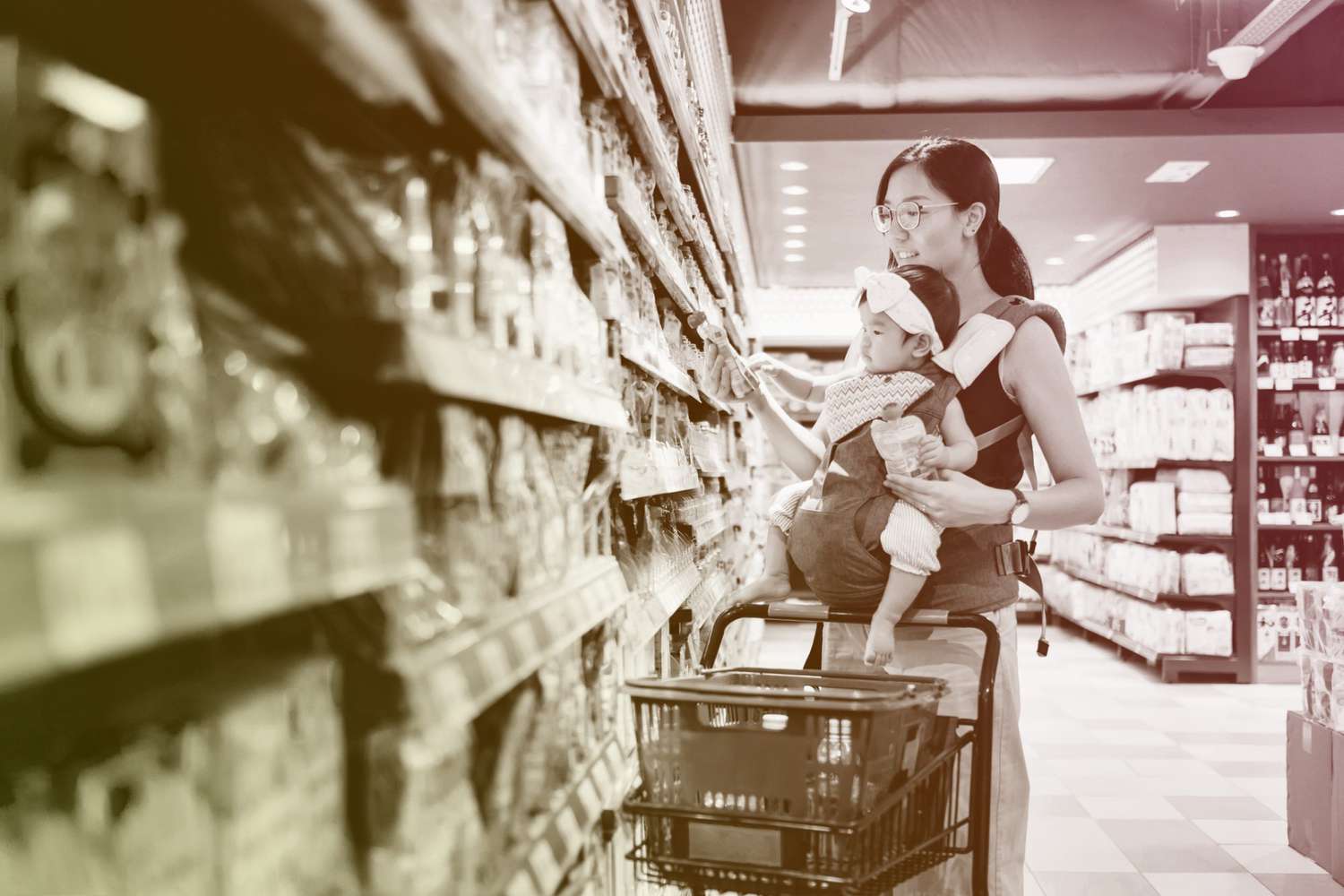 mother grocery shopping with baby girl in supermarket