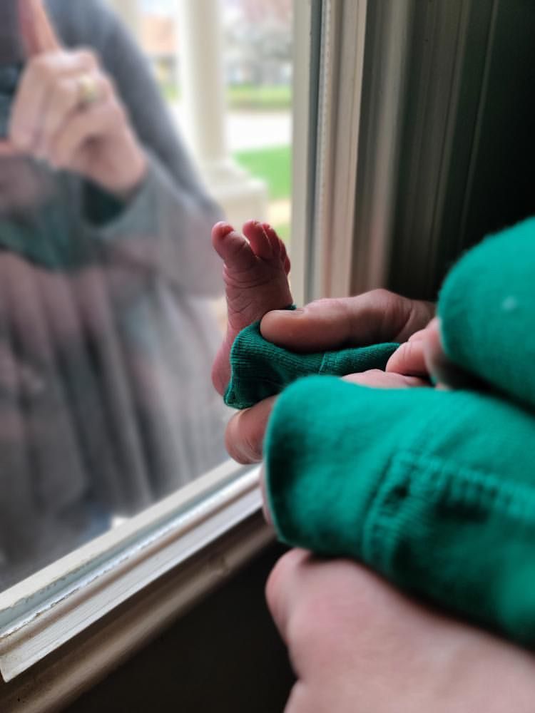 Maggie Mundwiller's baby's foot held up to the window