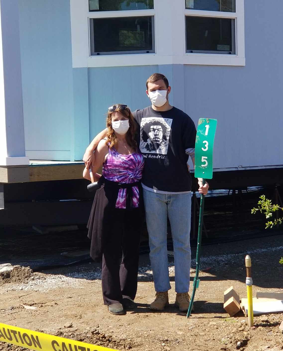 Cindy and Hunter in front of their new home