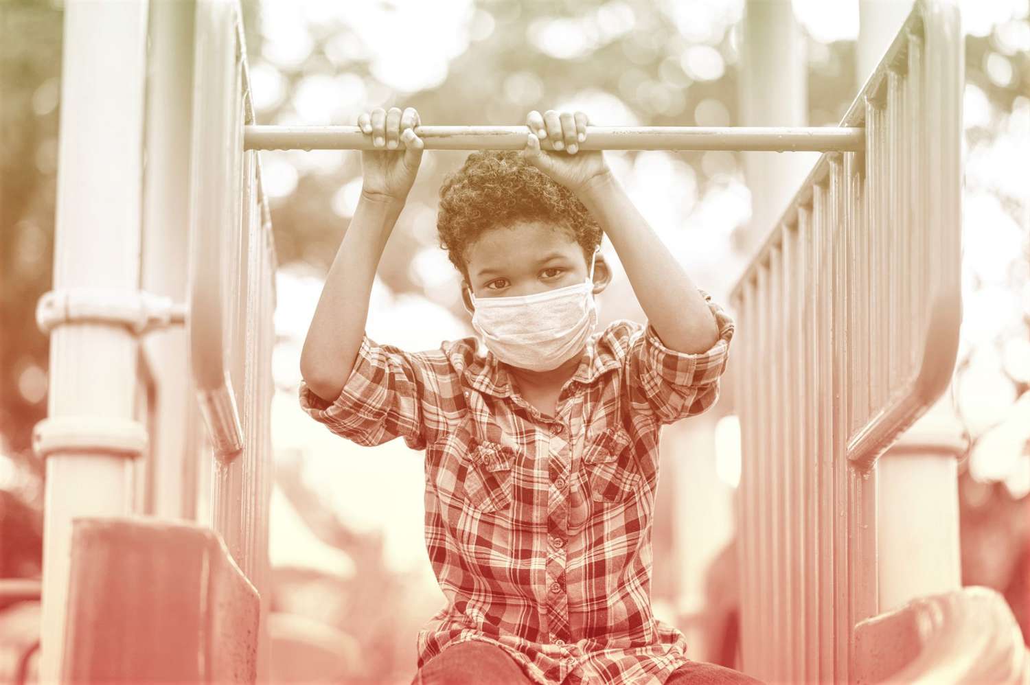 boy wearing protective face mask while playing at playground