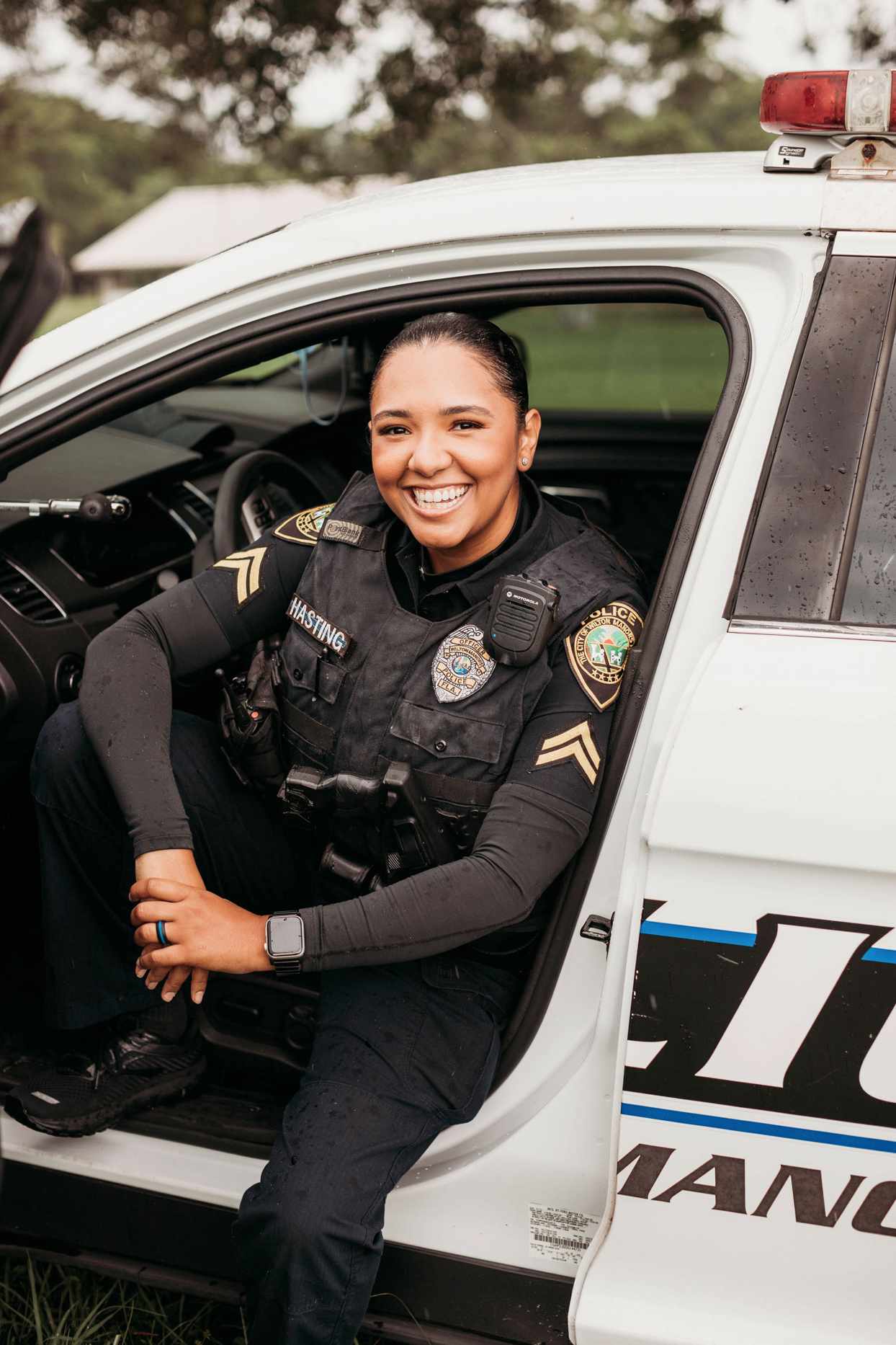 latina mom police officer in squad car