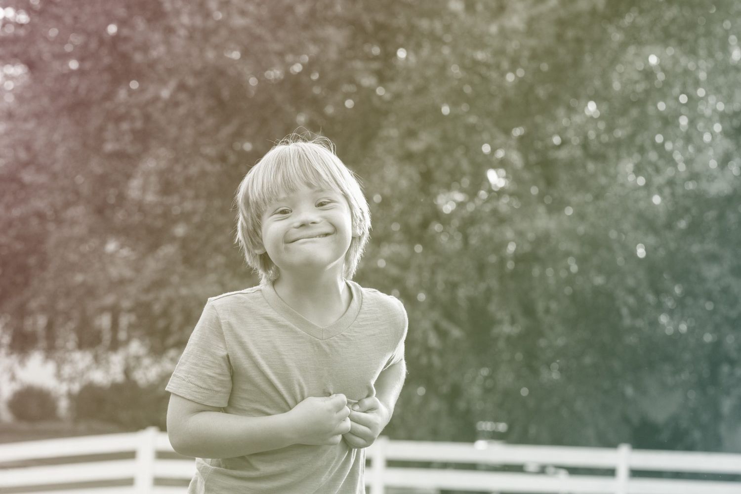 boy with Down Syndrome smiling outdoors